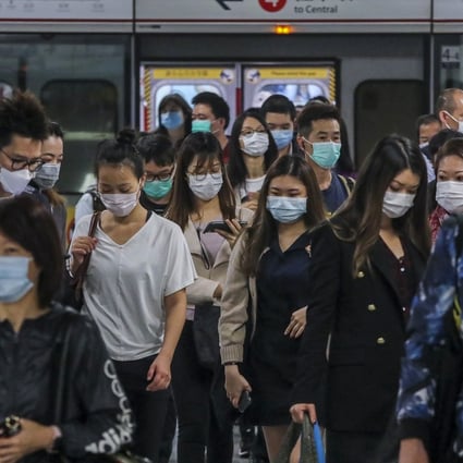 Commuters in masks at Admiralty station in Hong Kong. An expert says that while mainland China’s situation is stabilising, the contagion has spread worldwide. Photo: Felix Wong
