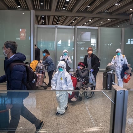 A family arrives in hazmat suits at Beijing Capital International Airport on March 4, 2020. Photo: EPA-EFE