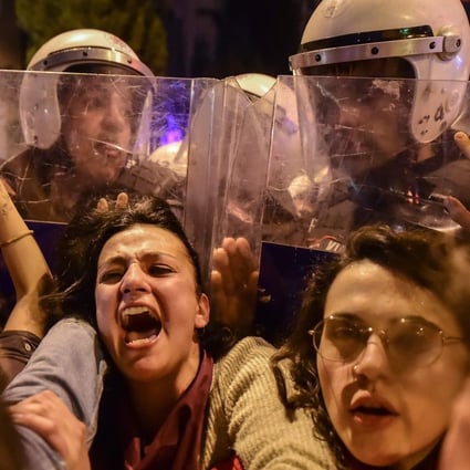Turkish anti-riot police push back women during a rally in Istanbul. Photo: AFP