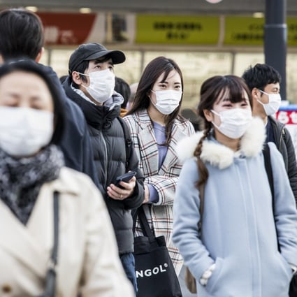 Commuters seen in protective masks in Tokyo on February 25, 2020. Photo: Bloomberg