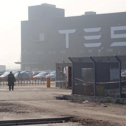 A Tesla sign is seen on the Shanghai Gigafactory of the US electric car maker before a delivery ceremony in Shanghai on December 30, 2019. Photo: Reuters