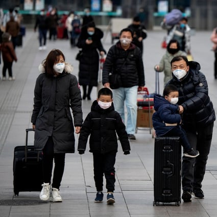 Passengers wearing facemasks arrive from different provinces at the Beijing Railway Station on February 1, 2020. Photo: AFP