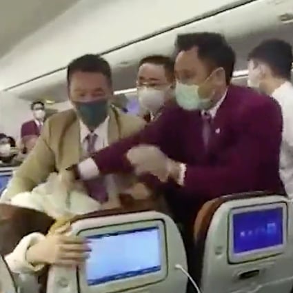 Video taken on board a Thai Airways flight at Shanghai on Friday purports to show flight attendants trying to control a passenger who coughed on one of their colleagues. Photo: Handout