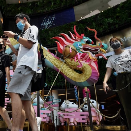 People wearing face masks amid concerns over the spread of Covid-19 walk through a Bangkok shopping centre. Photo: AFP