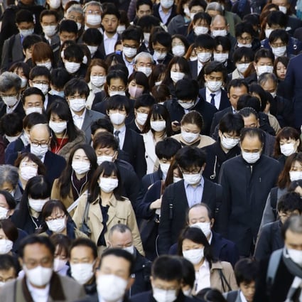 People wearing masks head to work in Tokyo, amid the spread of the new coronavirus. Photo: Kyodo