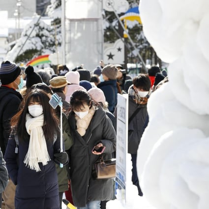 Visitors seen in masks at the annual Sapporo Snow Festival in Hokkaido, on February 4, 2020. Photo: Kyodo