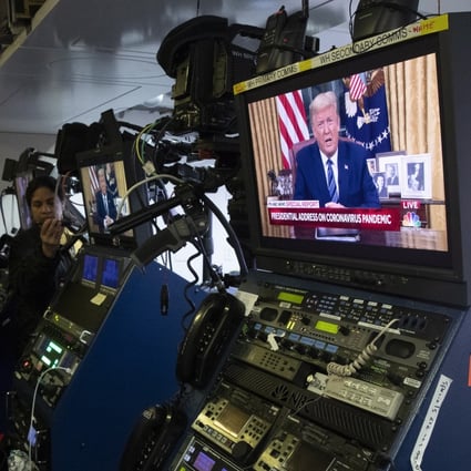 Members of the media watch a monitor showing US President Donald Trump giving a live address on the coronavirus epidemic from the Oval Office, inside the White House, on Wednesday. He announced the suspension of travel from the US to Europe for the next 30 days, excluding the UK. Photo: EPA-EFE