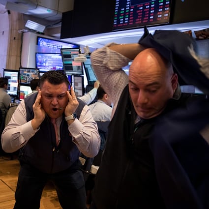 Traders working on the floor of the New York Stock Exchange react as the rout in global stocks deepened on Thursday after investors showed a lack of faith in the US and European policy responses to the worsening spread of the coronavirus. Photo: Bloomberg