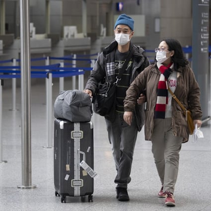 Passengers wearing masks make their way through the terminal at Frankfurt airport in Germany. Photo: AP