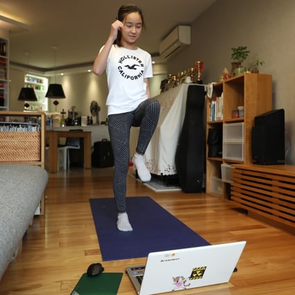 Kaitlyn Yu Ching, a Form One student at HKUGA College, attends an online physical education class from her home in Tai Koo. Photo: Xiaomei Chen