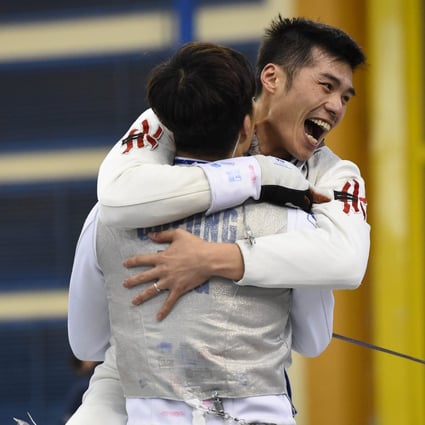 Cheung Siu-lun hugs teammate Cheung Ka-long after punching their Olympic tickets in Cairo. Photo: FIE