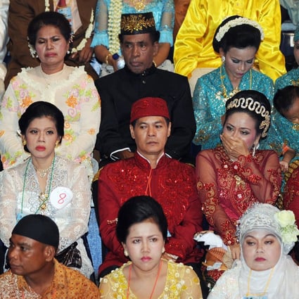 Indonesian couples wearing traditional outfits attend a mass interfaith wedding ceremony sponsored by the Jakarta government in Jakarta, Indonesia in 2011. Interfaith marriages are generally discouraged in the country. Photo: AFP