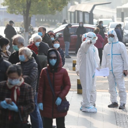 Recovered patients line up to be tested again at a hospital in Wuhan on Saturday. Researchers found unrecognised cases “can expose a far greater portion of the population to the virus than would otherwise occur”. Photo: AFP