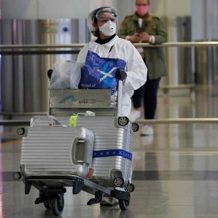 A passenger in protective suit arrives in Hong Kong, as travellers take extra precautions following the outbreak of the new Covid-19 coronavirus. Photo: Reuters