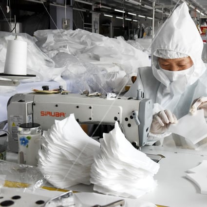 Workers make face masks at the workshop of a garment company which has changed its production line to produce protective materials in Qingdao, east China's Shandong Province, March 2, 2020. Photo: Xinhua/Li Ziheng