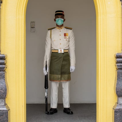 A Royal Malay Regiment Guard of Honour wears a protective face mask in Kuala Lumpur. Photo: AFP