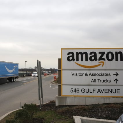 An Amazon Prime truck passes by a sign outside an Amazon fulfilment center, Thursday, March 19, 2020, on Staten Island, in New York. Photo: AP