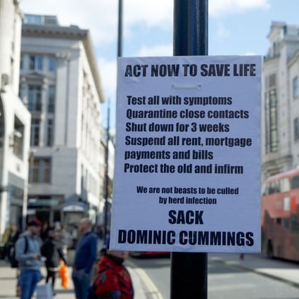 A sign prompting action because of a coronavirus outbreak, and calling for British Prime Minister Boris Johnson’s special adviser Dominic Cummings to be sacked, hangs on a lamp post on Oxford Street in central London on March 16. Retail has become a bellwether of the coronavirus crisis as China begins to recover and Europe goes into free fall. Photo: Bloomberg