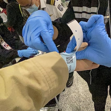 A passenger arriving into Hong Kong International Airport is one of the first to receive a tracking wristband on Thursday. Photo: Sam Tsang