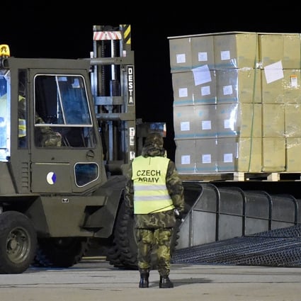 Soldiers unload a plane delivering medical and protective gear from China at an airport in the Czech city of Pardubice on Sunday. Photo: AFP