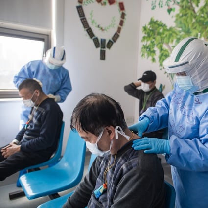 Medical workers massage patients' acupuncture points at the Wuhan pulmonary hospital in Wuhan. Photo: Xinhua