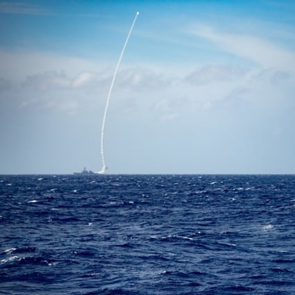 The guided-missile destroyer USS Barry (left) launches a missile during a live-fire exercise on Thursday. Photo: US Navy