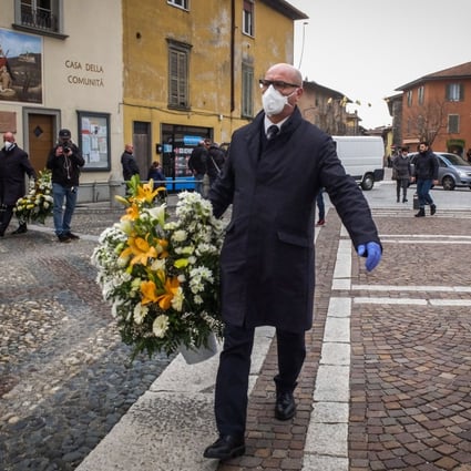 A mourner with a protective face mask attends a funeral service in Nembro, Italy, on March 7. The small town risks going down in history as having the highest percentage of victims in the coronavirus epidemic. Photo: EPA-EFE