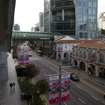 Pedestrians walk along a near-empty Orchard Road in Singapore on March 24. Photo: Bloomberg
