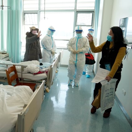 A woman who recovered from Covid-19 says farewell as she leaves hospital in Wuhan. Photo: Xinhua