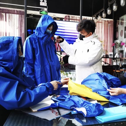 Beijing-based designer Liu Wei works on her windbreaker design during the coronavirus epidemic in China. She says protective clothing designed for specialists such as firefighters, disease prevention teams, and soldiers had found new appeal with members of the Chinese public.