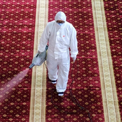 A worker disinfects a mosque near Kuala Lumpur, Malaysia, to guard against the coronavirus. Photo: Bloomberg