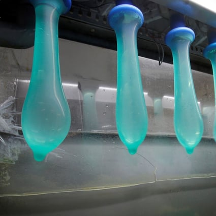 A worker performs a test on condoms at Karex’s factory in Pontian, Malaysia. Photo: Reuters