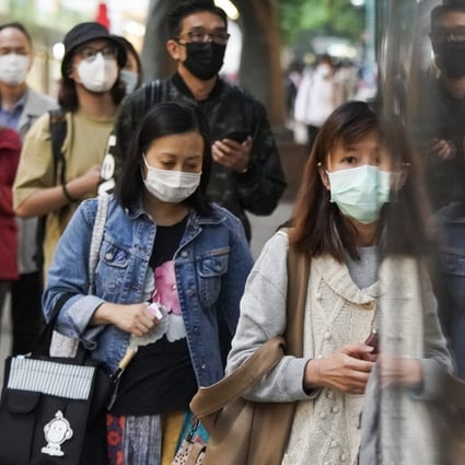 Pedestrians wearing face masks walk a street in the Tsim Sha Tsui district, following the outbreak of the new coronavirus in Hong Kong. Photo: Felix Wong