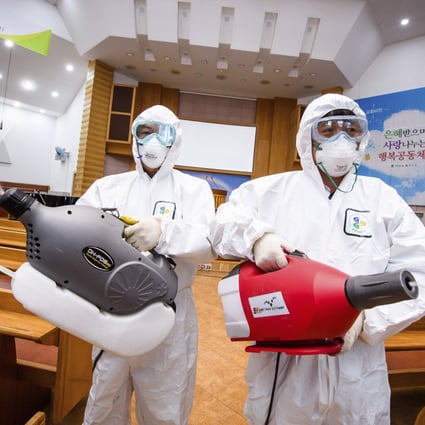 Workers spray disinfectant to help curb the spread of the coronavirus at a church in South Korea. A new cluster of infections has emerged at a church in Seoul’s western district of Guro. Photo: AP