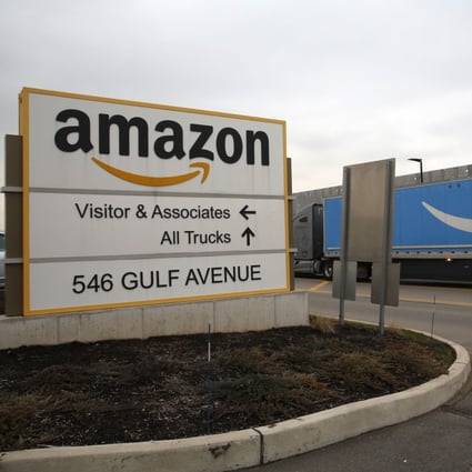 An Amazon Prime truck passes by the sign outisde an Amazon fulfillment center, Thursday, March 19, 2020, in Staten Island, New York. Photo: AP