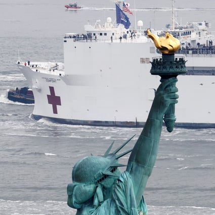 The USNS Comfort passes the Statue of Liberty as it enters New York Harbour on Monday. Photo: Reuters