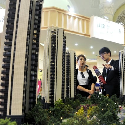 A sales assistant speaks to a customer at a property exhibition in Shanghai as home sales spring back to life after sales offices reopened across China. Photo: Reuters