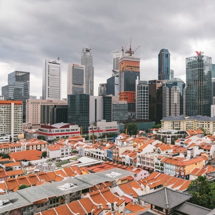 Skyscrapers stand beyond traditional shophouses in the central business district in Singapore. Photo: Bloomberg