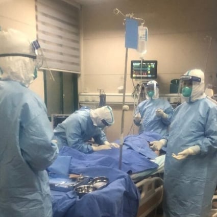 Intensive care doctors from Zhongnan Hospital in Wuhan treat a Covid-19 patient. Photo: Handout
