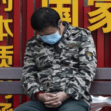 A resident naps near a sign that reads “Chinese dream” in Wuhan on Wednesday. Photo: AP