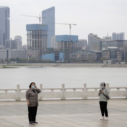 Residents observe social distancing at a park along the Yangtze River in Wuhan on Wednesday. Photo: AP