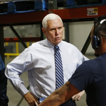 US Vice-President Mike Pence speaks with a worker at a Walmart distribution centre in Gordonsville, Virginia, on Wednesday. Photo: AP