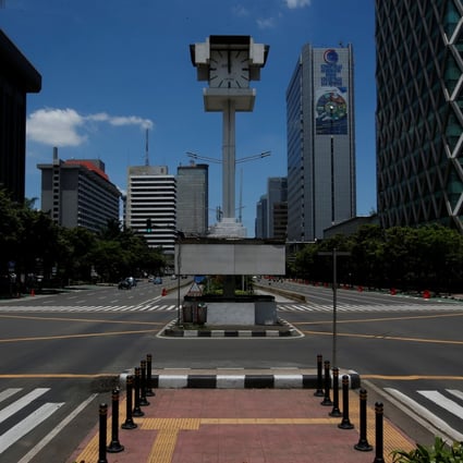 An almost empty intersection at noon on Jalan M.H. Thamrin, one of the main roads in Jakarta. Photo: Reuters