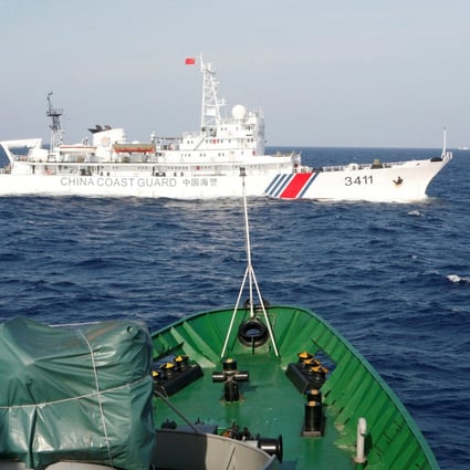 A Chinese Coast Guard ship is seen near a Vietnam Marine Guard ship in the South China Sea. Vietnam claims a Chinese vessel hit and sank a fishing boat near the Paracel Islands. Photo: Reuters