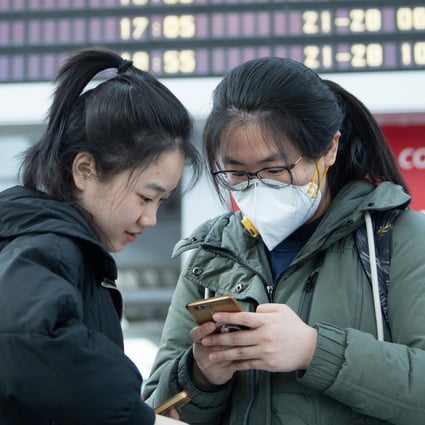 Chinese students stand in front of a departure board at Dresden Airport in Germany in March, as numerous flights are cancelled due to the coronavirus outbreak. Photo: dpa