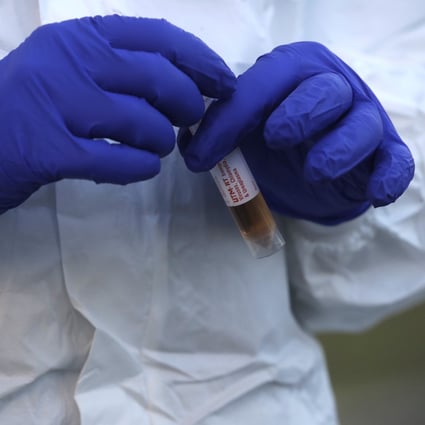 A medical worker takes samples at a Covid-19 drive-through testing station in Rome on Friday. Photo: AP