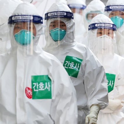 Nurses wearing protective suits line up to enter a treatment ward for Covid-19 patients in Daegu, South Korea. East Asia has received global acclaim for its success in fighting the coronavirus pandemic. Photo: DPA
