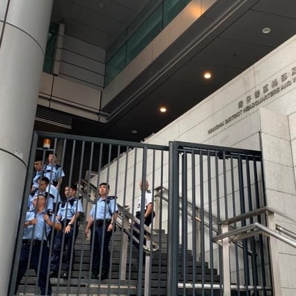 Officers behind the gates of the headquarters. Photo: Victor Ting