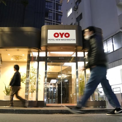 Pedestrians walk past an Oyo hotel in Tokyo. The start-up is placing thousands of employees on indefinite leave in a bid to survive the coronavirus pandemic. Photo: Bloomberg