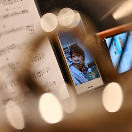Kazuhiko Sato of the New Japan Philharmonic Orchestra records himself in his soundproof room at home in Tokyo. Photo: Charly Triballeau/AFP